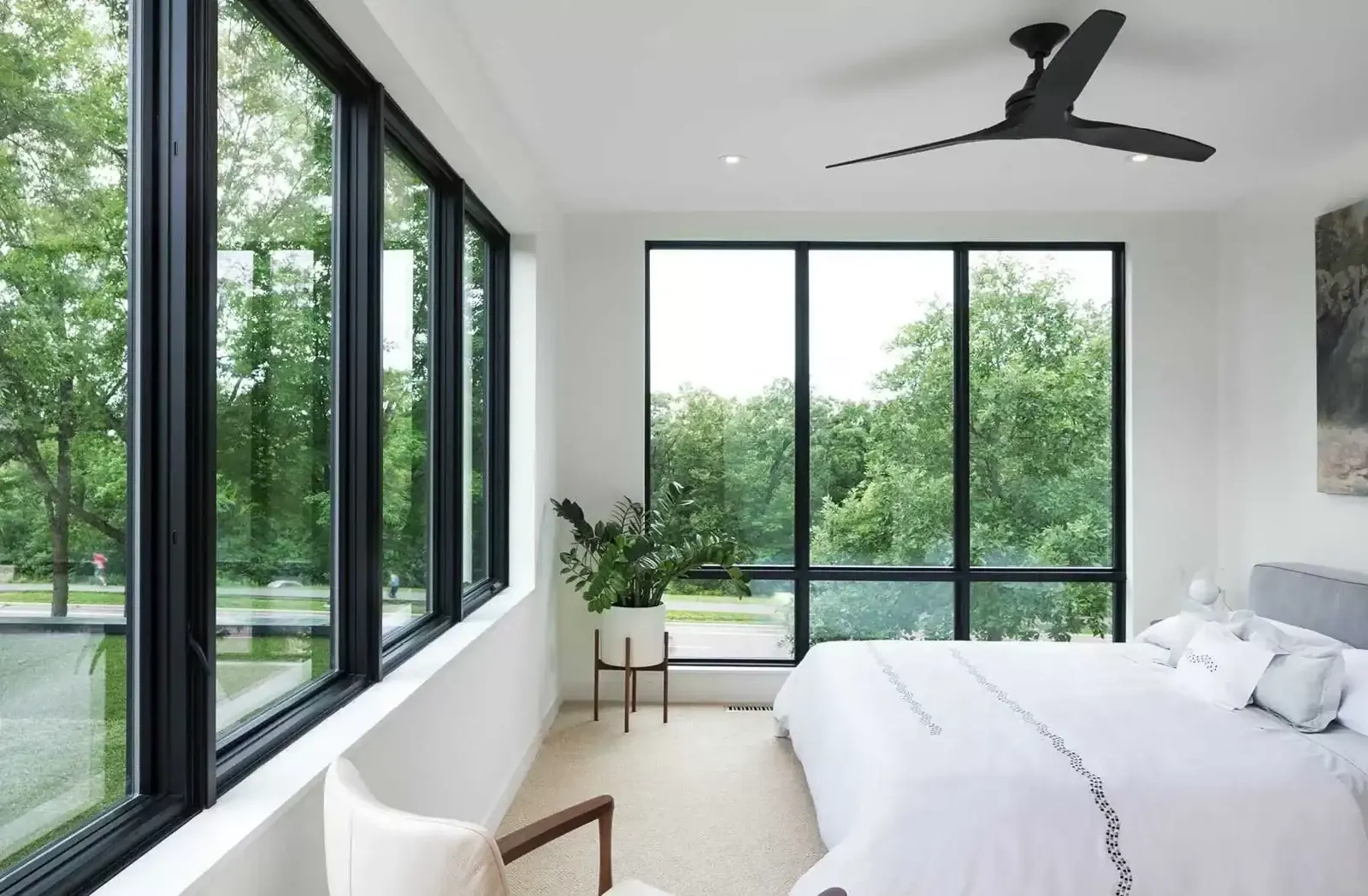 Bedroom with large black-frame replacement windows