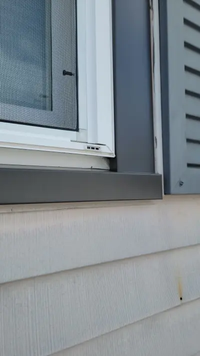 Navy blue vinyl lap siding installation in progress on a Boston, MA home - photo 5