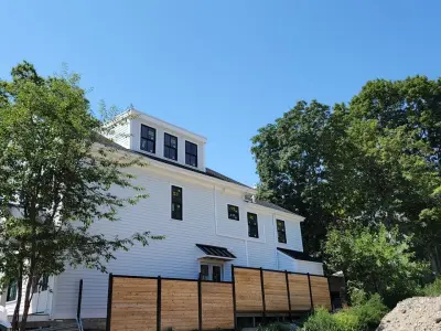 James Hardie white lap siding with black windows on a Boston, MA home - photo 5