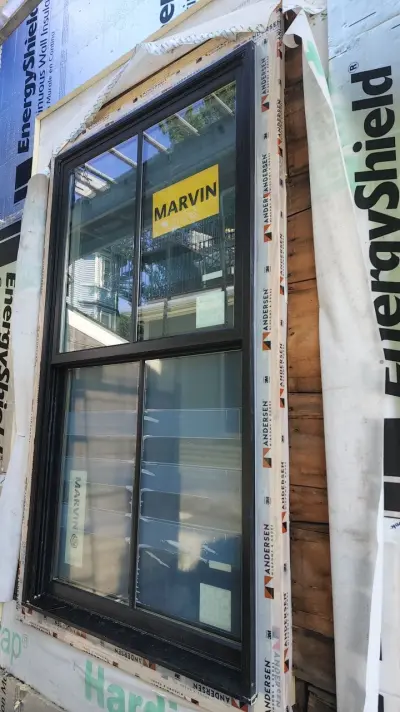 James Hardie white lap siding with black windows on a Boston, MA home - photo 27