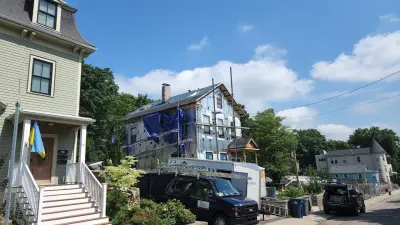 James Hardie white lap siding with black windows on a Boston, MA home - photo 29