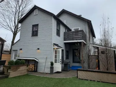 James Hardie white lap siding with black windows on a Boston, MA home - photo 53