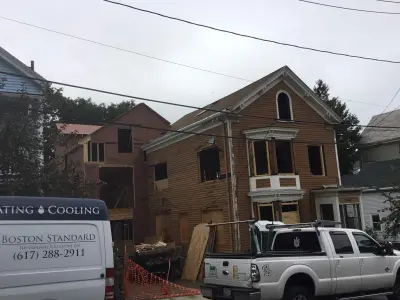 Golden ochre wood clapboard siding with black windows in Boston, MA - photo 8