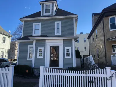 Slate gray CertainTeed siding with white trim on a home in Boston, MA