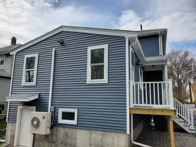 Blue-gray CertainTeed vinyl siding with white trim and porch in Braintree, MA - photo 4