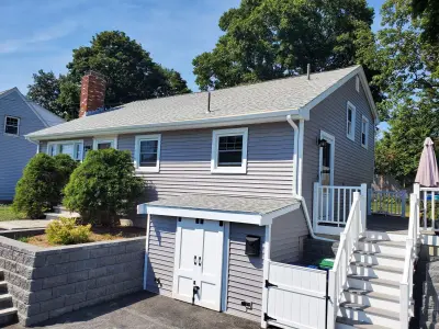CertainTeed gray siding and new GAF roofing on a Braintree, MA home