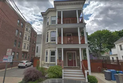 Navy James Hardie siding with cedar accents on a Cambridge, MA three-decker - photo 11