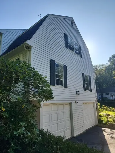 Light gray fiber cement lap siding with white trim on a gambrel home in Dover, MA - photo 32