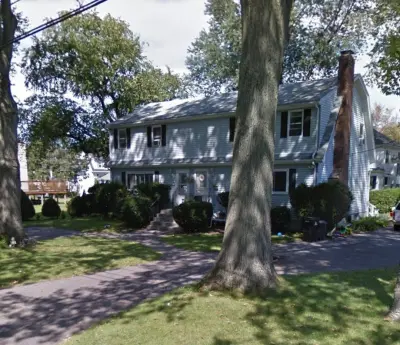 Blue James Hardie lap siding with white trim on a two-family in Framingham, MA