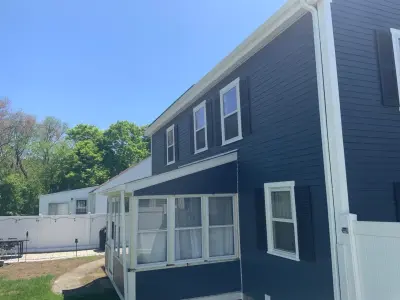 Deep navy James Hardie lap siding with white trim on a colonial in Framingham, MA