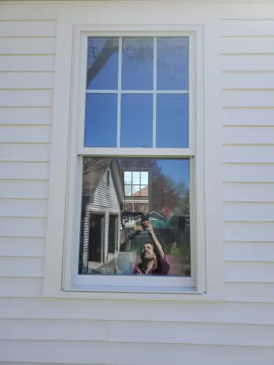 Second close-up of the same window type showing sill, apron and siding butt seam
