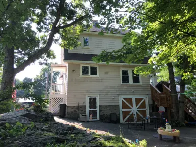 White CertainTeed vinyl siding with black shutters on a gambrel home in Malden, MA - photo 12
