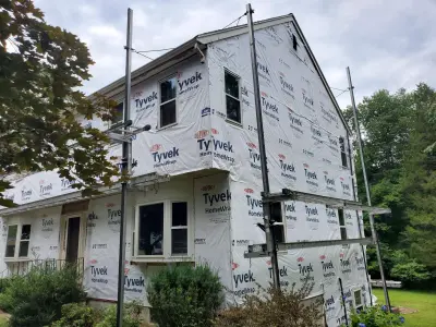 Deep brown CertainTeed vinyl siding with cream trim on a home in Marlboro, MA - photo 15