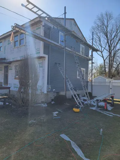 Slate blue James Hardie lap and shingle siding on a home in Maynard, MA - photo 18