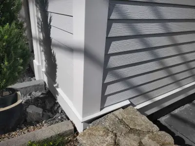White paneled entry door with fan light under molded pediment cap and lantern
