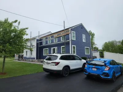 Deep navy vinyl lap siding with white trim on a colonial in Milford, MA - photo 15