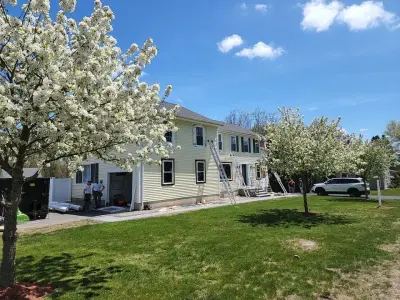 Deep navy vinyl lap siding with white trim on a colonial in Milford, MA - photo 31