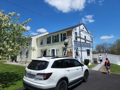 Deep navy vinyl lap siding with white trim on a colonial in Milford, MA - photo 32