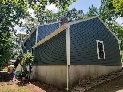 Deep blue-gray James Hardie lap siding on a colonial home in Milford, MA