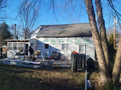 Barn red James Hardie lap siding with white trim on a cape home in Natick, MA - photo 35