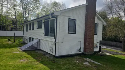 Full front view: raised ranch with two garage bays and side entry stair