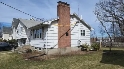 Blue-gray composite lap siding with white trim on a split-level home in Needham, MA - photo 22