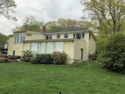 Pale cream lap siding on a split-level home in Newton, MA - photo 13