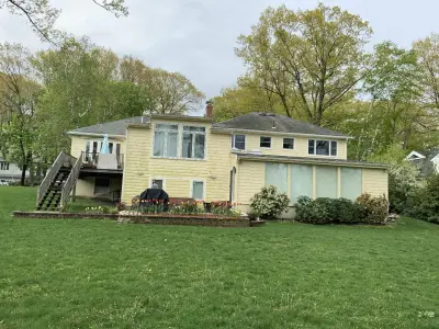 Pale cream lap siding on a split-level home in Newton, MA - photo 14