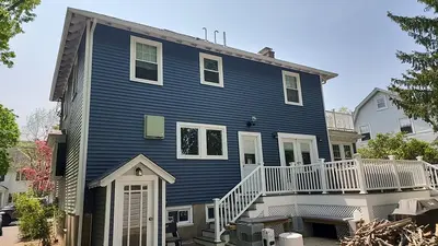 Before photo of the main house in chalky white clapboards