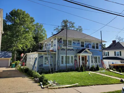 Light blue vinyl siding with white trim and black shutters on a home in Norwood, MA - photo 13