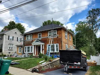 Light blue vinyl siding with white trim and black shutters on a home in Norwood, MA - photo 17