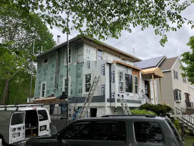 Gray-blue vinyl lap siding installation over housewrap in Quincy, MA - photo 5