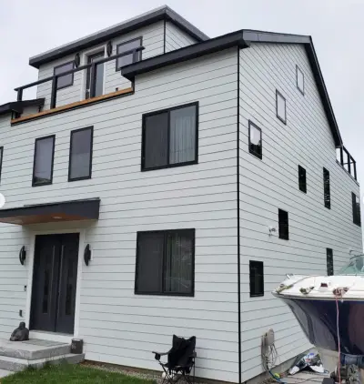 James Hardie white lap siding with black windows on a coastal home in Quincy, MA - photo 3