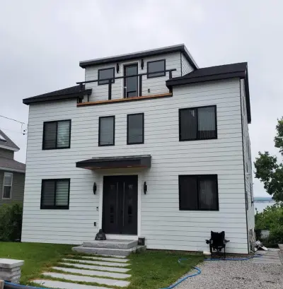 James Hardie white lap siding with black windows on a coastal home in Quincy, MA - photo 4