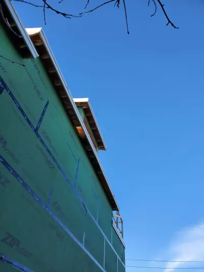 White James Hardie lap siding with black windows on a modern home in Quincy, MA - photo 7