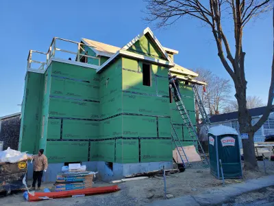 White James Hardie lap siding with black windows on a modern home in Quincy, MA - photo 10
