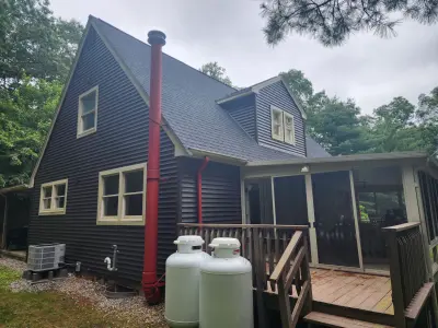 Dark blue-gray vinyl siding with beige trim on a gabled home in Upton, MA - photo 5