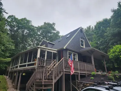Dark blue-gray vinyl siding with beige trim on a gabled home in Upton, MA - photo 6