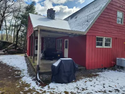 Dark blue-gray vinyl siding with beige trim on a gabled home in Upton, MA - photo 10
