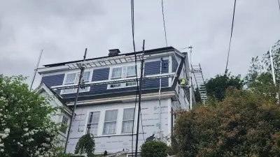 James Hardie navy siding and new windows going up in Watertown, MA