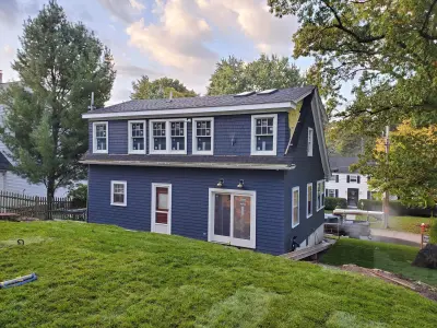 Navy-finished red cedar shingle siding with white trim on a home in Wellesley, MA - photo 29