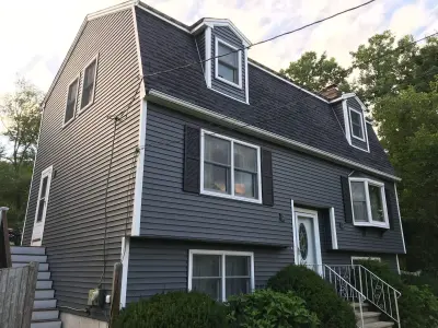 CertainTeed navy vinyl siding on a gambrel-roof home in Wilmington, MA - photo 5