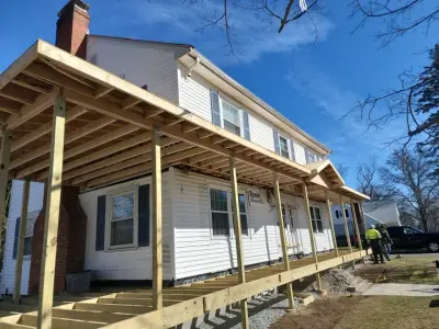 Composite porch decking with white railings on a home in Winchester, MA - photo 64