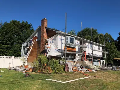 Entry and wall openings framed during a siding project in Woburn, MA - photo 25
