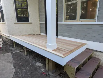 Corner bay with ZIP sheathing still exposed above the head trim and a transom door