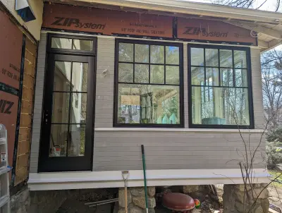 Light greige lap siding installation with black windows in Wellesley, MA - photo 9