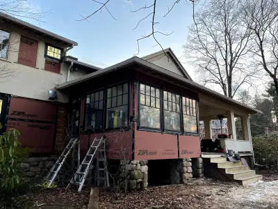 Light greige lap siding installation with black windows in Wellesley, MA - photo 28