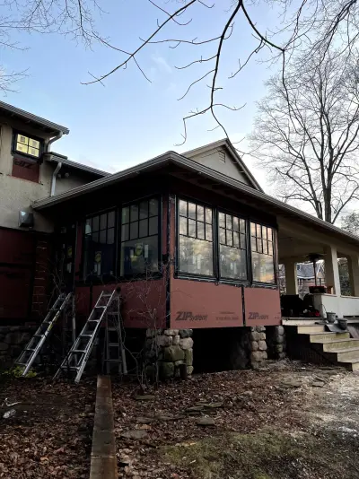 Light greige lap siding installation with black windows in Wellesley, MA - photo 29