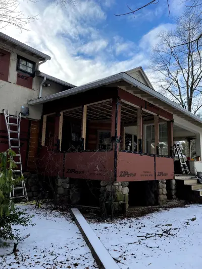 Light greige lap siding installation with black windows in Wellesley, MA - photo 31