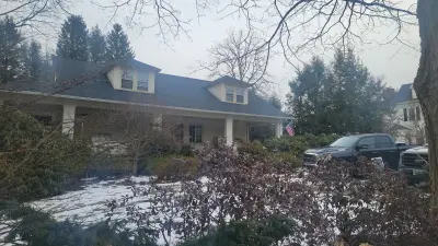 Light greige lap siding installation with black windows in Wellesley, MA - photo 39